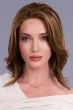 Woman in a shoulder length dark auburn curly human hair wig