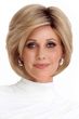 Woman in a long layered light brown pixie wig with side bangs