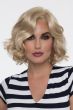 Woman in a chin length curly layered light blonde bob wig