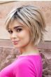 Woman in a shoulder length choppy light auburn bob wig with fringe bangs