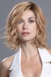 Woman in a shoulder length curly ginger blonde lace front bob wig