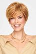 Short layered shag wig with side-swept bangs and crown volume in warm highlighted blonde tones