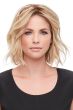 Woman in a wavy 12" light blonde human hair topper with an extra large base
