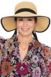 Woman in summer visor hat with big front brim, narrow back and black ribbon trim