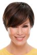 Woman in a long dark auburn pixie wig with side bangs