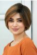 Woman in a chin length medium auburn rounded bob wig