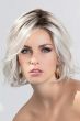 Woman in a past the chin curly white lace front wig