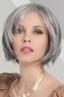 Woman in a chin length salt and pepper layered bob wig