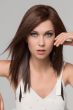 Woman in a dark brown straight past the shoulders wig with choppy layers