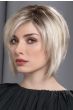 Woman in a past the chin platinum blonde stacked bob wig with choppy layers and side bangs