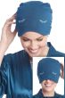Women in blue bamboo sleeping cap with embroidered eyelashes that doubles as a sleep mask for cancer patients