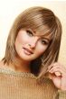 Woman in a dark blonde shoulder length bob wig with razored ends and side swept bangs