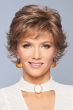 Woman in a flipped out brown grey short wig with wispy bangs
