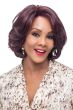 Woman in a chin length curly dark burgundy layered wig