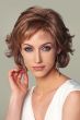 Woman in a light ginger brown layered bob wig with wispy bangs