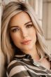 Woman in a past the shoulders light blonde straight lace front wig
