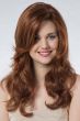 Woman in an extra long medium auburn curly lace front wig