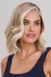 Woman in an auburn shoulder length blunt bob wig with curled under ends