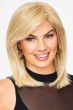 Woman in a past the shoulder straight pale blonde wig with side bangs