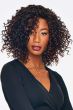Black woman in a shoulder length dark brown and red curly layered wig