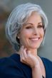 Woman in a light brown chin length lace front bob wig with extra volume along the forehead
