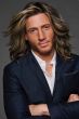 Man in a shoulder length layered medium brown lace front wig
