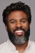 Black man in a curly dark brown close cropped lace front wig