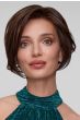 Woman in a light blonde angled chin length bob wig with dark roots