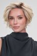 Woman in a light blonde angled chin length bob wig with dark roots