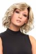 Woman in a shoulder length light blonde curly lace front wig