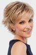 Woman in a textured light blonde pixie wig with long straight layers on top and curly short layers along the back and sides