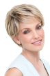 Woman in a blonde classic pixie style wig with feathered bangs and darker layers