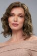 Woman in a shoulder length dark auburn curly lace front wig