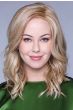 Woman in a past the shoulders curly red blonde lace front wig