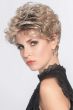Woman in a curly light blonde pixie wig with longer layers on top