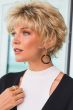Woman in short blonde wig with textured layers and bangs