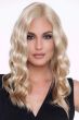 Woman in a past the shoulders wavy light blonde lace front wig