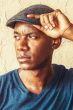 Cool guy in grey herringbone driver cap or flat hat