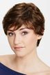 Woman in a medium brown pixie wig with fringe bangs