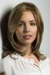 Woman in a 13" layered light brown wiglet with long 4" side bangs