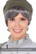 Woman in a short straight grey halo hair piece under an olive beanie hat