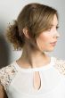 Woman in a light auburn curly hair scrunchie
