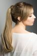 Woman in a 18" straight light brown clip on ponytail