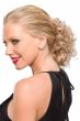 Woman in an 8" curly light blonde clip on updo hairpiece