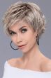 Woman in a long ash blonde lace front pixie wig with tousled hair in back