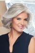 Woman in a shoulder length volume-infused curly grey bob wig