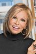 Raquel Welch in a shoulder length reddish blonde straight bob wig with choppy layers