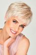 Woman in a petite short, semi-wavy pixie wig with short textured bangs