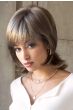 Woman in brown medium length shag wig with layers and flipped out ends