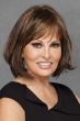 Woman in shoulder length brunette wig with light brown highlights and bangs